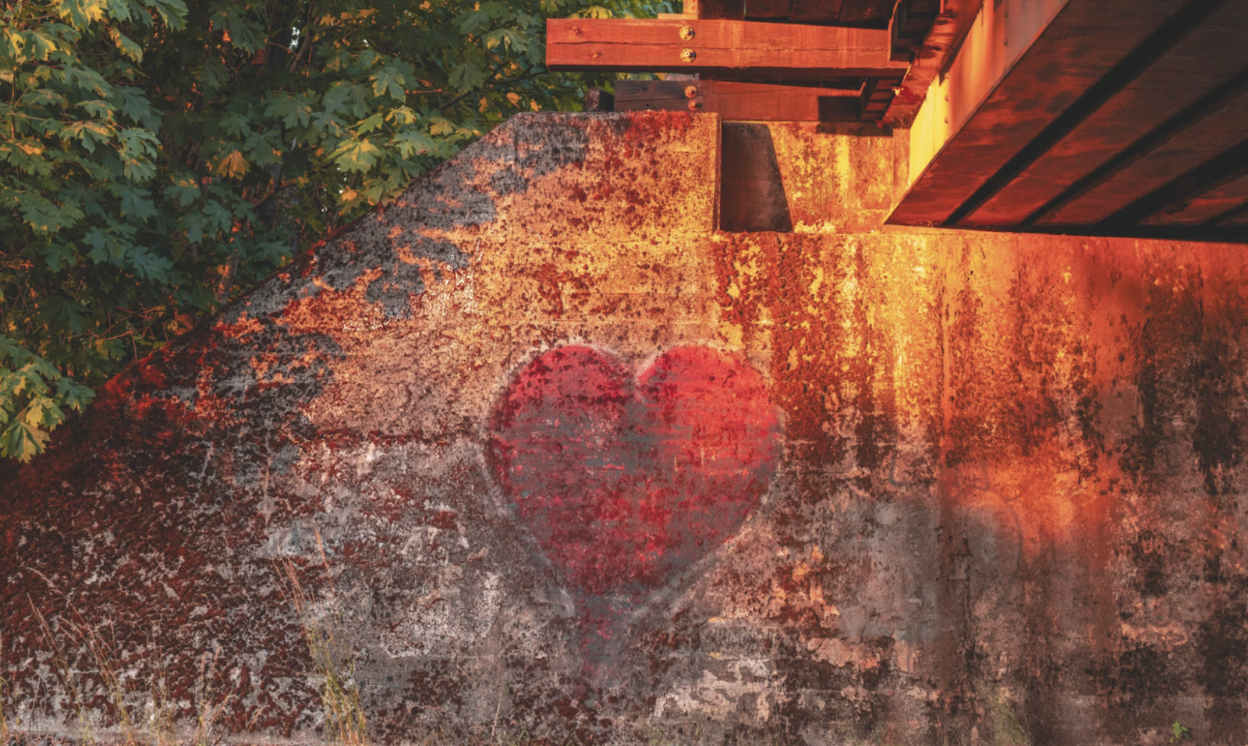 Graffiti heart painted on a concrete underpass wall